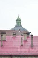 Fragment of a metal roof of the restored old multi-storey building in Lviv, Ukraine photo