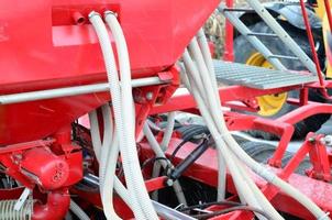 Springs and tubes are arranged in a row. A row of seeder. Heavy equipment on agricultural exhibition photo