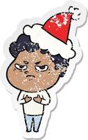 distressed sticker cartoon of a angry man wearing santa hat vector