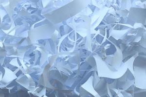 Shredded paper texture background, top view of many white paper strips. Pile of cut paper like box filler for shipping fragile items photo