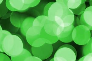 Green abstract Christmas blurred luminous background. Defocused artistic bokeh lights image photo