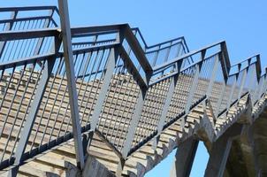 A fragment of a stepped ascent to the pedestrian bridge between the platforms of the railway station photo