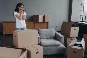 New first home, relocation. Female homeowner feels happiness standing in empty room on moving day photo