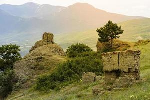 Mountain landscape, stone pillars in the form of ghosts, stone idols in a mountain valley, a canyon against the sky. photo