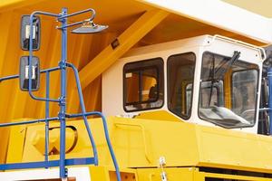 Large yellow dump truck. Close-up, cabin, body. photo