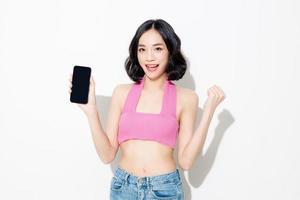 Fashionable asian woman short hair with Perfect body using mobile phone. Cute female model and sparkling eyes on white isolated background. Facial treatment, Cosmetology, beauty Concept. photo