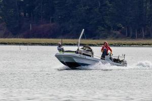 Arne, Dorset, UK - September 20. View of a boat passing Arne in Dorset on September 20, 2022. Two unidentified people photo