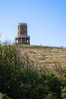 Kimmeridge Bay, Dorset, UK - September 21. View of Clavell Tower at Kimmeridge Bay in Dorset on September 21, 2022. Two unidentified people photo