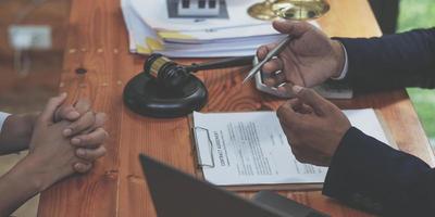 Business people negotiating a contract. man hands working with documents at desk and signing contract. Closeup view. photo