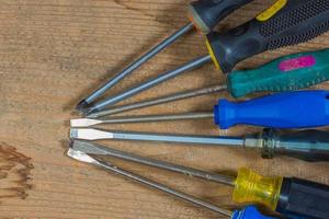 Different tools on a wooden background. Different screwdrivers photo