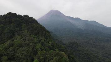 Aerial view of Merapi Mountain in indonesia with tropical forest around it