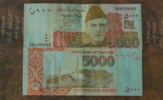 Money of Pakistan. Pakistani rupee bills. PKR banknotes. 500 1000 5000 rupees. Business, finance, news background. pakistani currency notes. photo