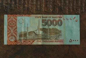 Money of Pakistan. Pakistani rupee bills. PKR banknotes. 500 1000 5000 rupees. Business, finance, news background. pakistani currency notes. photo