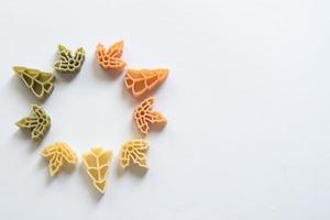 Circle with raw pasta. Tree and leaves shaped photo