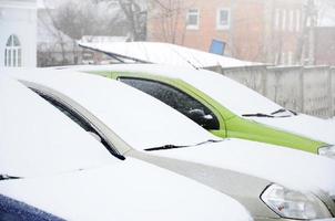 Fragments of parked cars covered with snow photo