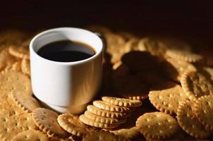 Small coffee cup and salted cracker photo