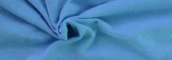 The texture of the fabric in blue color. Material for making shirts and blouses photo