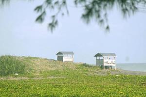 photo of a hut for shelter people on the beach in the daytime