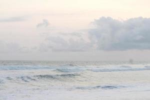 photo of beach scenery on a sunny day, visible beach sand and coastal waters