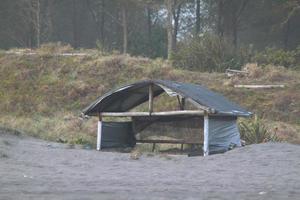 photo of a hut for shelter people on the beach in the daytime