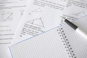 Handwriting of geometrical tasks on examination, practice, quiz or test in geometry class. Solving exponential equations concept. photo