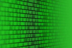 An image of a binary code made up of a set of green digits on a black background photo