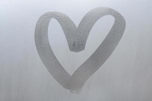 Autumn rain, the inscription on the sweaty glass - love and heart. Soft and beautiful background image with copy space photo