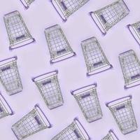 Pattern of many small shopping carts on a violet background. Minimalism flat lay top view photo