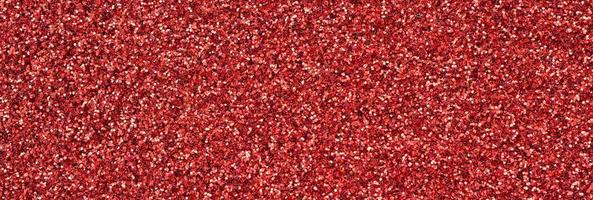 Crimson red decorative sequins. Background image with shiny bokeh lights from small elements photo