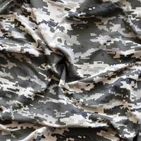 Fabric with texture of Ukrainian military pixeled camouflage. Cloth with camo pattern in grey, brown and green pixel shapes. Official uniform of Ukrainian soldiers photo