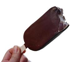 Cutout Close up a hand holding popsicle ice cream stick chocolate flavor in hand, transparent, isolated, object with clipping path photo