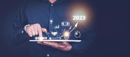 Startup concept with icon business and network connection on modern virtual interface from digital tablet. man touching on tablet. online business, e-comers, online marketing photo