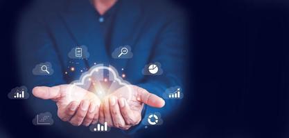 Big data analytics and business intelligence concept with chart and graph icons on a digital screen interface and a businessman in background photo