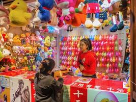 fenghuang,Hunan.China-16 October 2018.Unacquainted Chinese people or tourist Playing Local Street Shooting Game in fenghuang old town.phoenix ancient town or Fenghuang is a county of Hunan Province photo