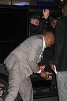 LOS ANGELES, JAN 23 - Nick Nolte, with Oscar Williams picking up beer bottle that fell out of car when door was opened arrives at the Luck Los Angeles Premiere of HBO Series at Graumans Chinese Theater on January 23, 2012 in Los Angeles, CA photo