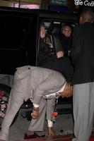 LOS ANGELES, JAN 23 - Nick Nolte, with Oscar Williams picking up beer bottle that fell out of car when door was opened arrives at the Luck Los Angeles Premiere of HBO Series at Graumans Chinese Theater on January 23, 2012 in Los Angeles, CA photo