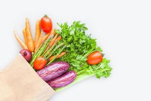 Fresh organic vegetables in craft shopping bag photo