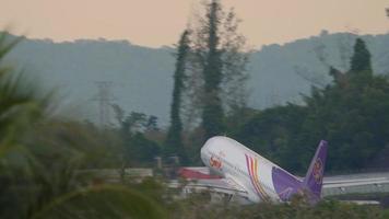 PHUKET, THAILAND NOVEMBER 26, 2019 - Thai Smile Airbus 320 departing from Phuket airport. View from the top floor of the Splash Beach Resort hotel, Phuket, Thailand video