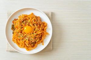 stir-fried udon noodles with kimchi and pork photo