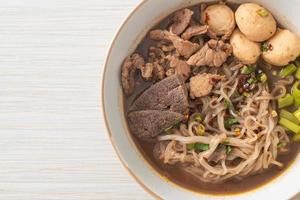 Thai noodle with pork, stewed pork, meatball and pork liver in blood soup photo