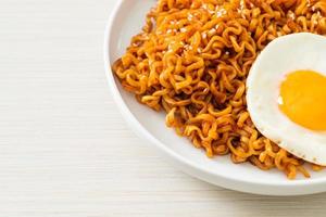 dried Korean spicy instant noodles with fried egg photo