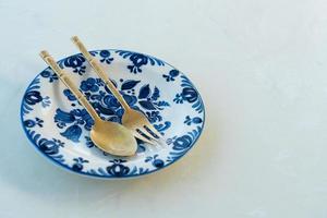 beautiful vintage porcelain plate on white table photo