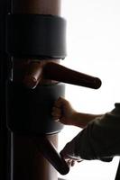 Silhouette of a fighter Wing Chun and wooden dummy on a background. Wing Chun Kung Fu Self defense photo
