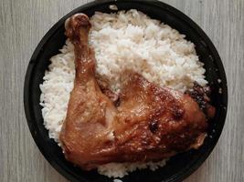 Baked chicken with rice in a plastic bowl photo