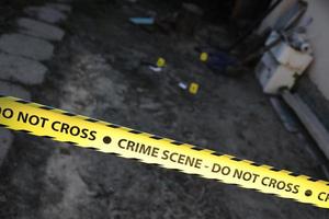 Crime scene tape for covering the area cordon. Yellow tape with blurred forensic law enforcement background in cinematic tone photo