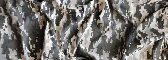 Fabric with texture of Ukrainian military pixeled camouflage. Cloth with camo pattern in grey, brown and green pixel shapes. Official uniform of Ukrainian soldiers photo