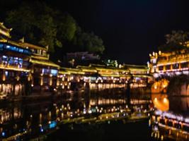 abstract Blur photo of Scenery view in the night of fenghuang old town .phoenix ancient town or Fenghuang County is a county of Hunan Province, China
