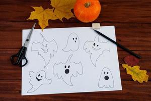 Halloween DIY. Step by step instructions on how to draw funny ghosts. photo