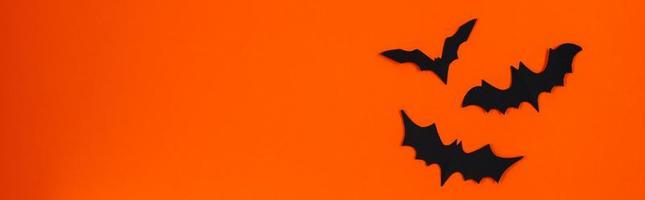 Happy Halloween. Paper bats on orange background. photo