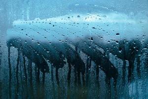 Texture of misted glass in autumn. Drops of water on window photo